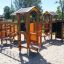 Alpha playhouse with slide in un parco giochi soleggiato