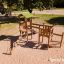 Triangle Modern Nature wooden playhouse with slide in un parco giochi.