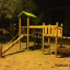Triangle Modern Nature wooden playhouse with slide di notte