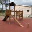 Triangle Modern Nature wooden playhouse with slide sul parco giochi all'aperto