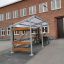 Bike Parking II ricovero per biciclette all'aperto con struttura in metallo e dettagli in legno