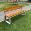 Tallin Bench w/ Backrest su un tratto d'erba vicino a un sentiero.