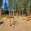 Attrezzatura fitness all'aperto in legno Bars II in un ambiente forestale.