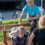 Bambini che usano la panca per sit-up in una palestra all'aperto.
