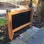 Esterno 'Blackboard' con struttura in legno collocata in un parco.