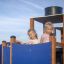 Bambini che giocano su Steamboat ship with slide in un'area giochi