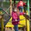 Ragazza con giacca rossa sul ponte del parco giochi della casa di Alice.