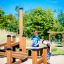 Bambini che giocano sulla struttura da gioco Sand & Water Play 2 in un parco.