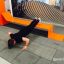 Uomo che si allena sulla panca fitness all'aperto Ribbon Fitness II.