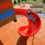 Bambino che scivola giù da uno scivolo rosso del parco giochi su Rubber Tiles 35.