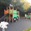 Big Tractor playhouse with slide in un parco giochi.