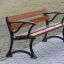 Bordeaux Bench w/ Armrests su un sentiero del parco.