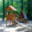 Galapagos wooden playhouse with slide in un'area giochi nel bosco