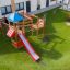 Parco giochi all'aperto con uno scivolo rosso e una struttura per arrampicarsi per bambini.