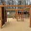 Motor Function Center Nature, wooden playhouse con parete da arrampicata, spalliera e scivolo.