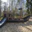 Attrezzatura da parco giochi per bambini Small Ship Nature in un contesto boschivo.