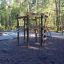 Sherwood wooden playhouse in un parco giochi circondato da alberi.