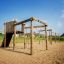 Kampinos wooden playhouse in un parco giochi soleggiato.