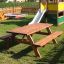 Larchwood Table & Bench in un parco giochi con scivolo sullo sfondo