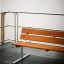 Bench, Steel Construction su una terrazza in legno vicino all'acqua.