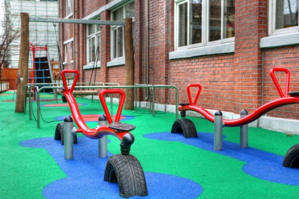 Area giochi con altalene rosse su superficie Wetpour 60.