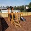 Fortress Nature playhouse with slide in un parco giochi.