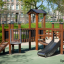 Fortress Nature playhouse with slide in un parco giochi all'aperto