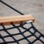 Primo piano di Hammock con barra di legno e rete di corde nere