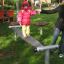 Bambino in equilibrio sulla trave Wonderland Trim Trail in un parco giochi.