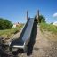 Scivolo in acciaio inox Hill Slide h150 in un parco giochi all'aperto.