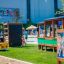 Climbing box wooden playhouse in un affollato parco giochi all'aperto.