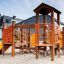 Rubik playhouse with slide in un parco giochi