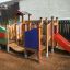 Rubik playhouse with slide in un parco giochi.