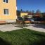 Area di parco pubblico con più 'Bench, Steel Construction' posizionati su superficie pavimentata.