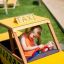 Bambino che gioca in un'auto da parco giochi a tema Taxi.