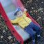 Bambino che si diverte su Fire-station playhouse with slide.