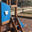 Police station playhouse with slide in un parco giochi