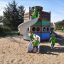 Bambini che giocano su Majestic ship with slide in un parco giochi sabbioso.