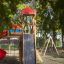 Twister castle with slide in un parco circondato da alberi.