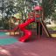 Twister castle with slide in un parco giochi colorato circondato da alberi