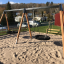 Double Swing (BNS 90cm) in un'area giochi sabbiosa.