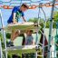 Bambini che giocano sulla struttura in acciaio Andromeda nel parco giochi.