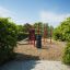 Attrezzatura da gioco fitness all'aperto 'New Age Fit' in un parco verde.