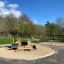 Villa Maxi sandbox with a playhouse in un parco giochi circondato dalla natura.