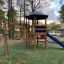 Struttura da parco giochi Six Angle with Suspension Bridge single slide in un contesto di parco