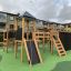Struttura outdoor Explorer castle with slide in un parco giochi.