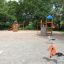 Logo Tower with Firepole playhouse with slide in un parco giochi.