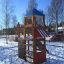 Logo Tower with Firepole playhouse with slide in un parco giochi innevato