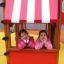 Due ragazze in un Logo Tower with Firepole playhouse with slide.
