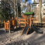 Smart Modern Nature wooden playhouse with slide in un contesto di parco giochi
